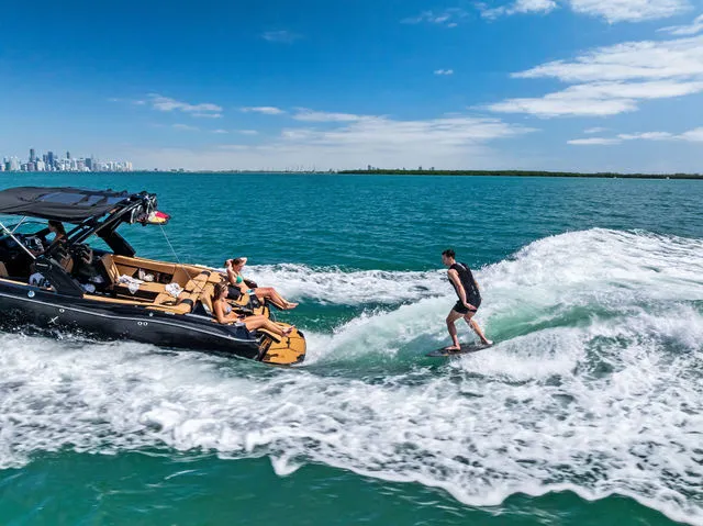 Slide: The Image of 2024 MasterCraft X24 boat covered, parked on a trailer in a sheltered area. - 5