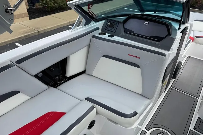 Slide: The Image of 2020 MasterCraft XStar boat interior with sleek gray and white seating, modern dashboard. - 10
