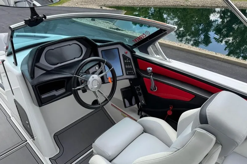Slide: The Image of 2020 MasterCraft XStar boat interior with modern dashboard and sleek steering wheel design. - 11