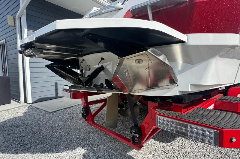 Slide: The Image of 2020 MasterCraft XStar boat on trailer, rear view showing hull and propeller. - 13