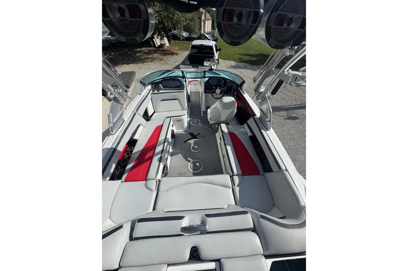 Slide: The Image of 2020 MasterCraft XStar boat interior with red and gray seating, sleek design. - 16