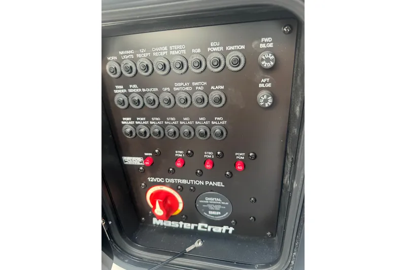 Slide: The Image of Control panel of a 2020 MasterCraft XStar boat with various switches and indicators. - 20