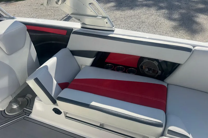 Slide: The Image of 2020 MasterCraft XStar interior with red and gray seating, cup holders, and speaker. - 27