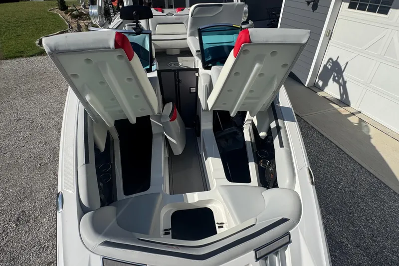 Slide: The Image of 2020 MasterCraft XStar boat interior with open storage compartments, showcasing sleek design and functionality. - 30
