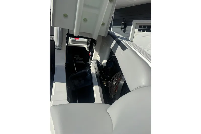 Slide: The Image of 2020 MasterCraft XStar interior storage compartment with open seat and visible speaker. - 31
