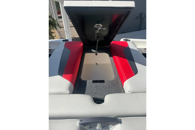 Slide: The Image of 2020 MasterCraft XStar boat interior with open storage compartment, red and gray seating. - 32
