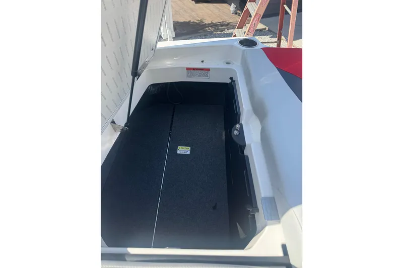 Slide: The Image of Open storage compartment of a 2020 MasterCraft XStar boat, showing interior details. - 33