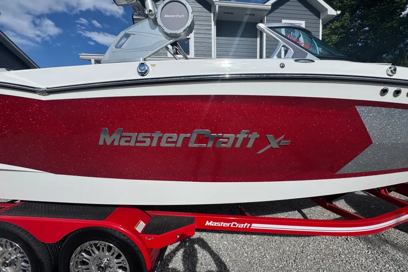 Slide: The Image of 2020 MasterCraft XStar boat with red glitter finish on a matching trailer. - 35