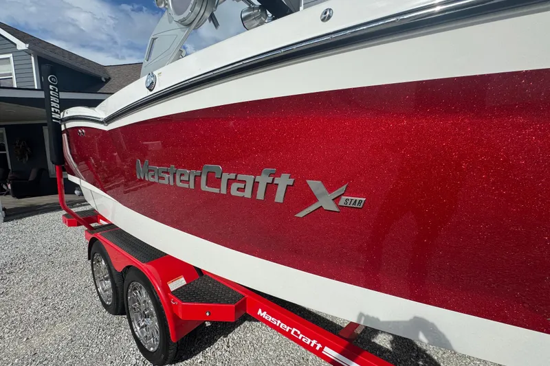 Slide: The Image of 2020 MasterCraft XStar boat with red glitter finish on a matching trailer. - 5