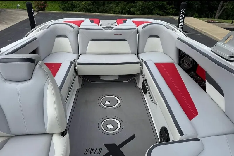Slide: The Image of 2020 MasterCraft XStar boat interior with red and white seating, featuring premium audio system. - 8