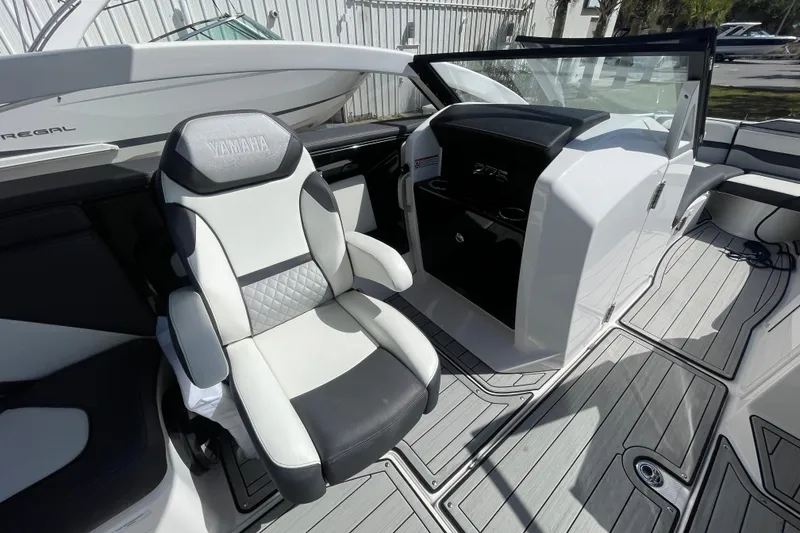 Slide: The Image of 2021 Yamaha Boats 275SE interior with sleek seating and modern dashboard design. - 10