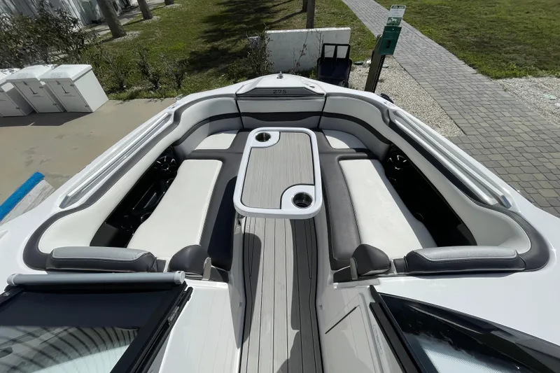 Slide: The Image of 2021 Yamaha Boats 275SE interior with spacious seating and table setup. - 13