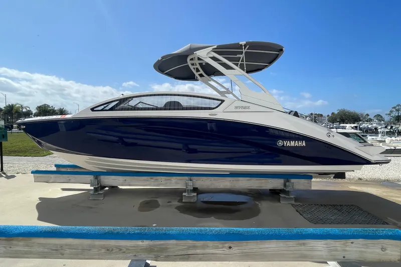 Slide: The Image of 2021 Yamaha Boats 275SE on display, featuring sleek design and modern canopy. - 5