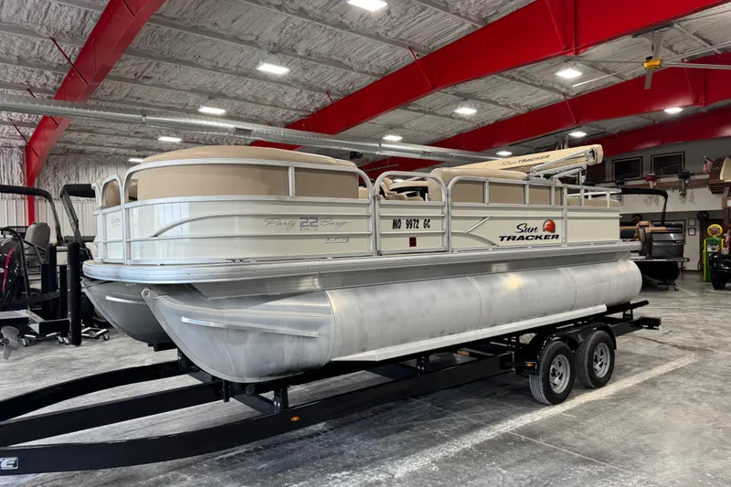 The Image of 2016 Sun Tracker Party Barge 22 XP3 pontoon boat in a spacious indoor showroom. - 1