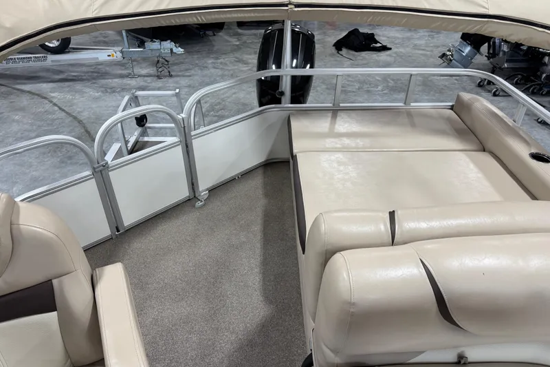 Slide: The Image of 2016 Sun Tracker Party Barge 22 XP3 interior with beige seating and carpeted floor. - 11