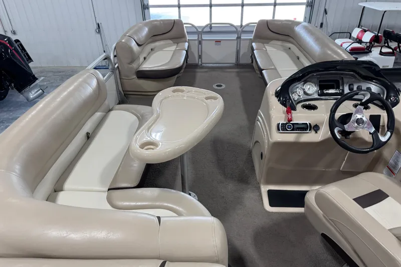 Slide: The Image of Interior of a 2016 Sun Tracker Party Barge 22 XP3 with beige seating and steering console. - 12