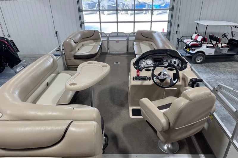 Slide: The Image of 2016 Sun Tracker Party Barge 22 XP3 interior with beige seating and steering console. - 14