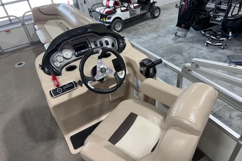 Slide: The Image of 2016 Sun Tracker Party Barge 22 XP3 helm with beige seating and control panel. - 15