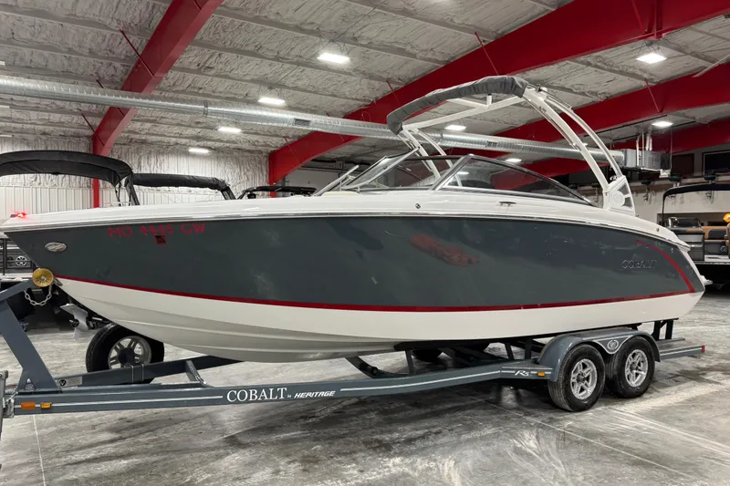 The Image of 2019 Cobalt R5 boat on trailer in indoor showroom with red accents. - 1