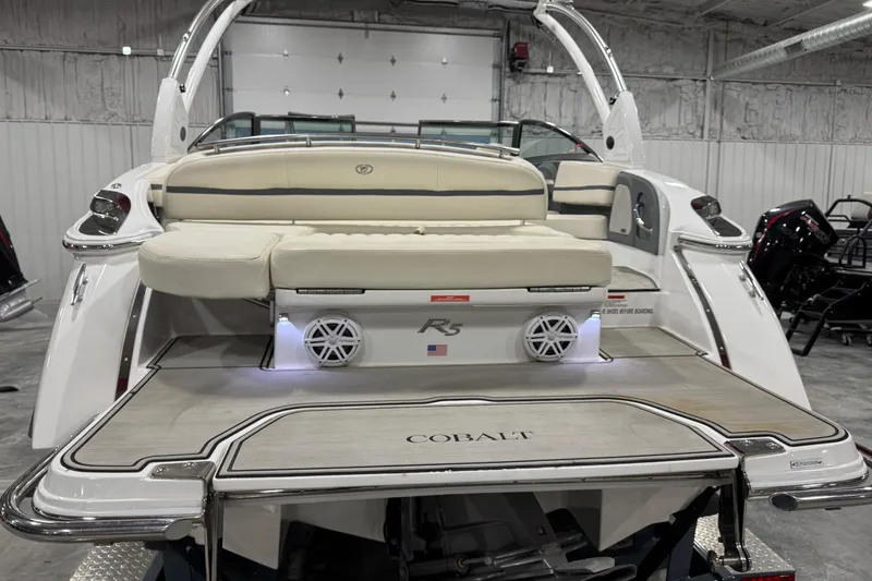Slide: The Image of 2019 Cobalt R5 boat interior with beige seating and sleek design in a showroom. - 4