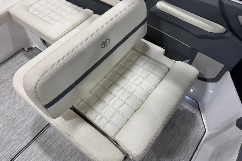 Slide: The Image of 2019 Cobalt R5 boat interior with white cushioned seating and modern design. - 8