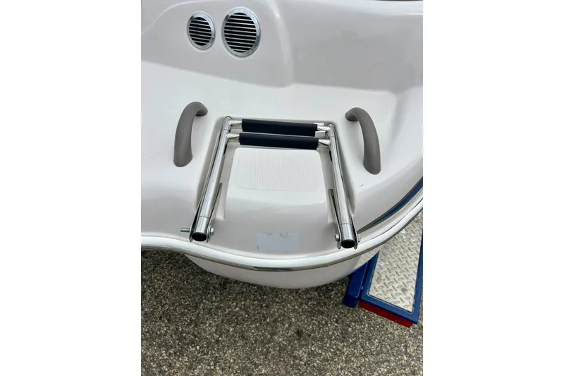 Slide: The Image of 2004 Tahoe Q4 boat ladder and handles on a white deck. - 10