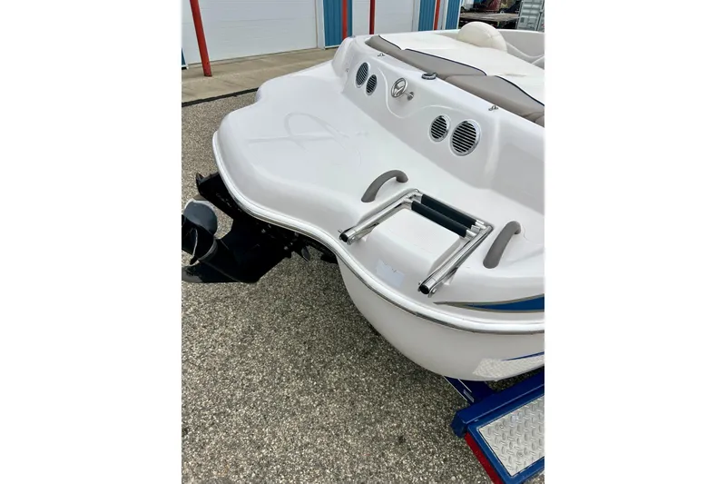 Slide: The Image of 2004 Tahoe Q4 boat rear view with swim platform and ladder. - 11