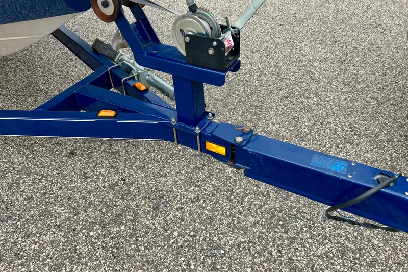 Slide: The Image of Blue trailer hitch of a 2004 Tahoe Q4 on asphalt surface. - 14