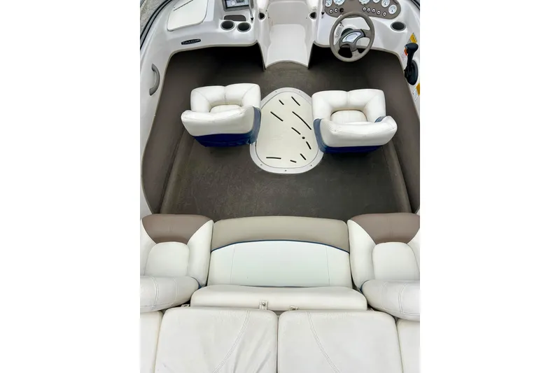 Slide: The Image of Interior of a 2004 Tahoe Q4 boat with white and beige seating. - 17