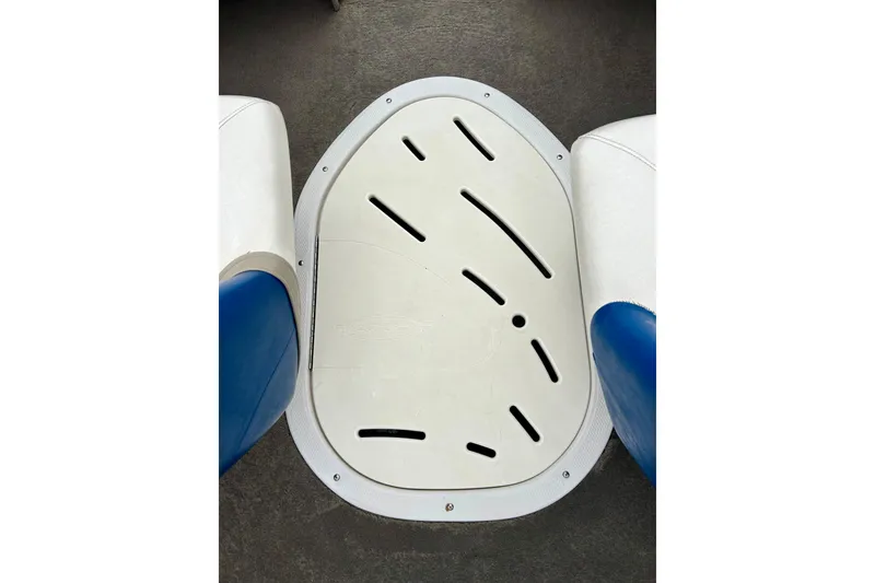 Slide: The Image of 2004 Tahoe Q4 boat interior with white and blue seating and a central hatch. - 18