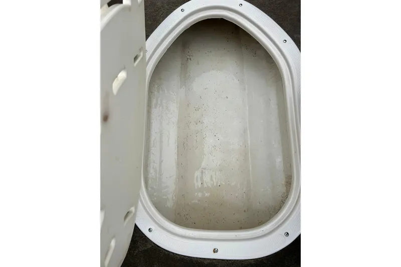 Slide: The Image of Open storage compartment in 2004 Tahoe Q4 boat, showing interior space. - 19