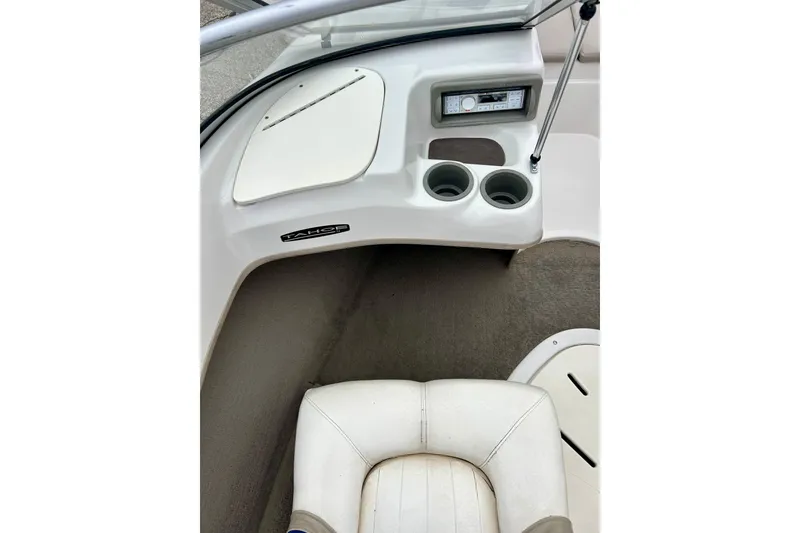 Slide: The Image of 2004 Tahoe Q4 boat interior with dashboard, cup holders, and seating. - 21