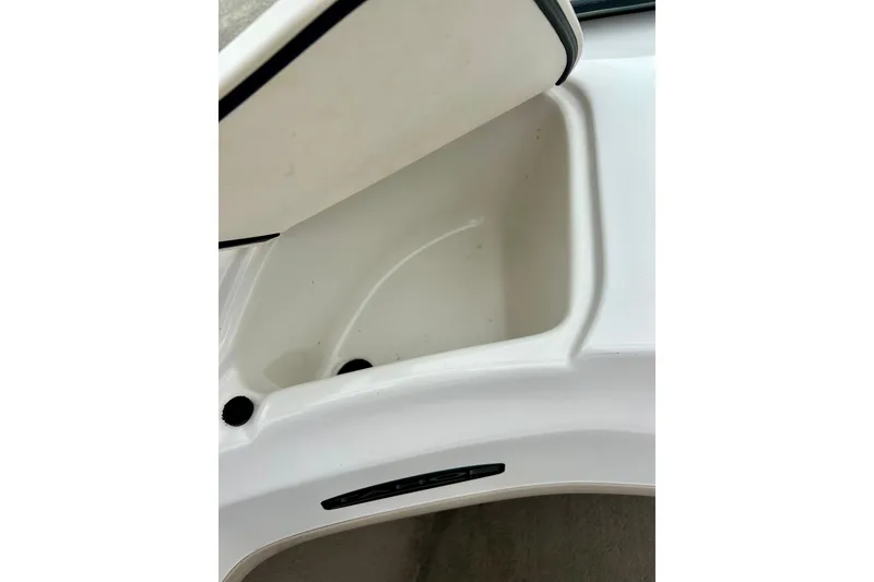 Slide: The Image of Storage compartment in a 2004 Tahoe Q4 boat, featuring a white interior. - 22