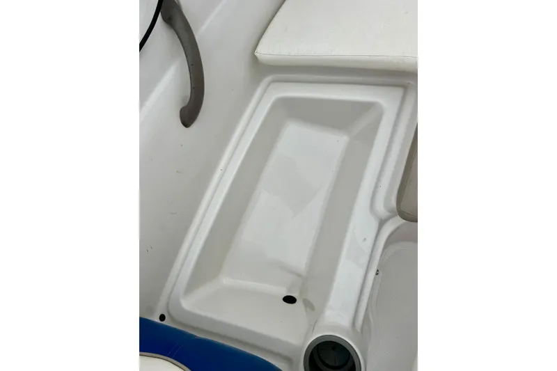Slide: The Image of 2004 Tahoe Q4 boat interior detail with white seating and cup holder. - 24