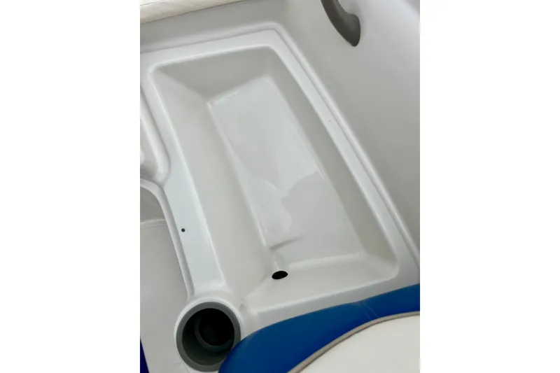 Slide: The Image of 2004 Tahoe Q4 boat interior detail with cup holder and seating area. - 26
