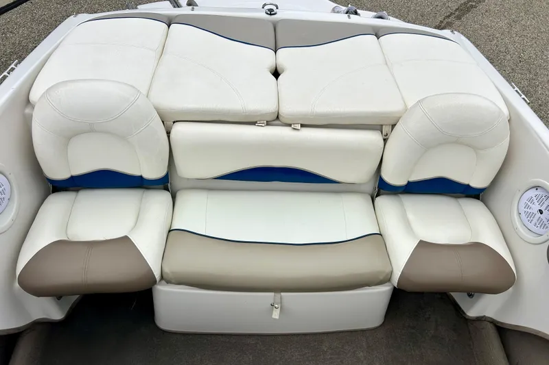 Slide: The Image of 2004 Tahoe Q4 boat interior with white and beige cushioned seating. - 29