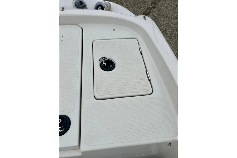 Slide: The Image of 2004 Tahoe Q4 boat deck with storage compartments and latch details. - 30