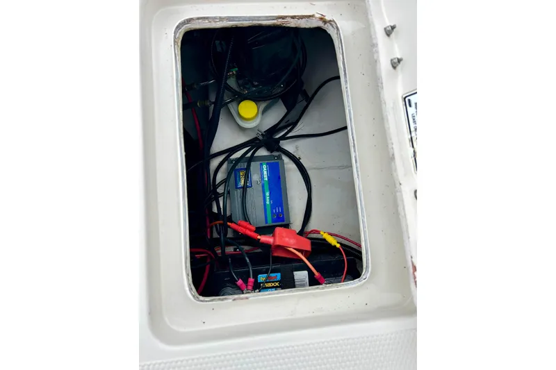 Slide: The Image of Electrical compartment of a 2004 Tahoe Q4 boat, featuring wiring and battery components. - 31