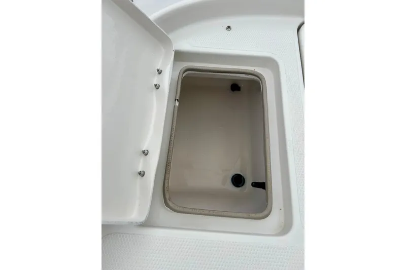 Slide: The Image of Open storage compartment on a 2004 Tahoe Q4 boat, showcasing interior details. - 33