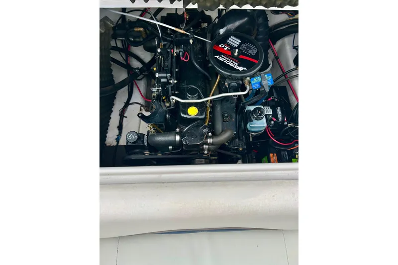 Slide: The Image of Engine compartment of a 2004 Tahoe Q4 boat, featuring a MerCruiser 3.0 motor. - 34