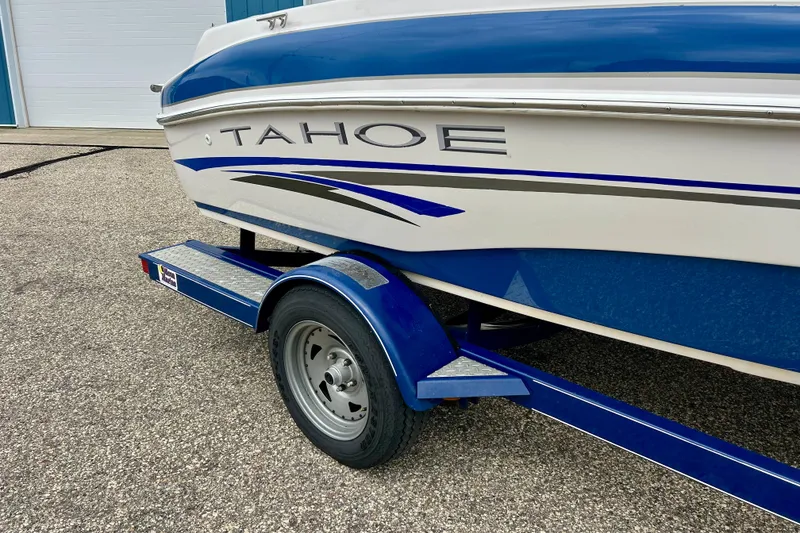 Slide: The Image of 2004 Tahoe Q4 boat on trailer, featuring blue and white design with bold graphics. - 5