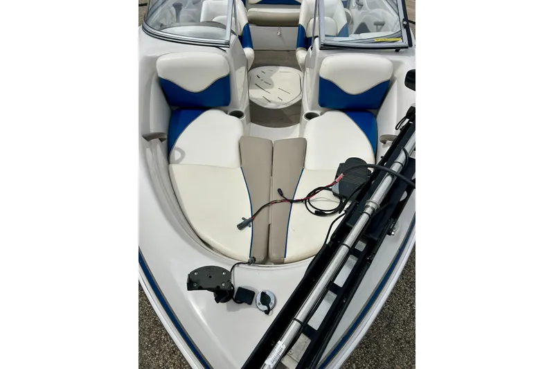 Slide: The Image of 2004 Tahoe Q4 boat interior with blue and white seating and equipment. - 7