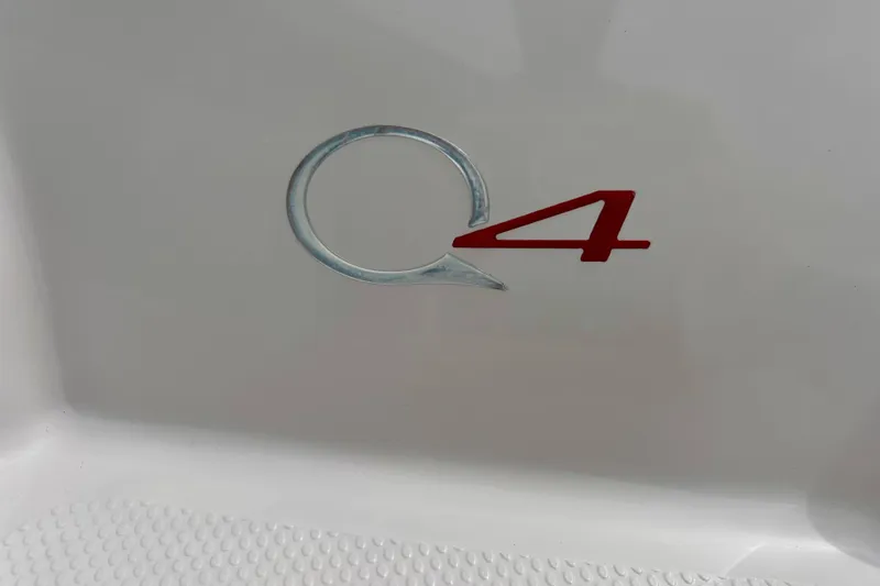 Slide: The Image of Close-up of 2004 Tahoe Q4 logo on white surface. - 9