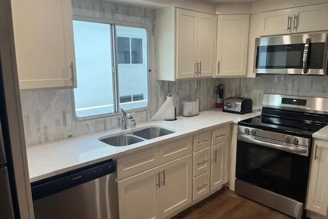 Slide: The Image of Modern kitchen in a 2003 Fantasy 18x80 houseboat with stainless steel appliances. - 10