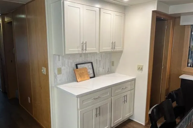 Slide: The Image of White cabinetry in a 2003 Fantasy 18x80 houseboat interior, featuring a marble backsplash. - 11