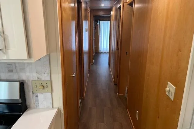 Slide: The Image of Interior hallway of a 2003 Fantasy 18x80 Houseboat with wooden paneling. - 13