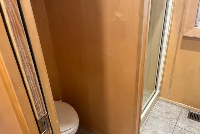 Slide: The Image of Small bathroom with toilet and shower in 2003 Fantasy 18x80 houseboat. - 15