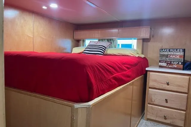Slide: The Image of Cozy bedroom in 2003 Fantasy 18x80 houseboat with red bedding and wooden furniture. - 16