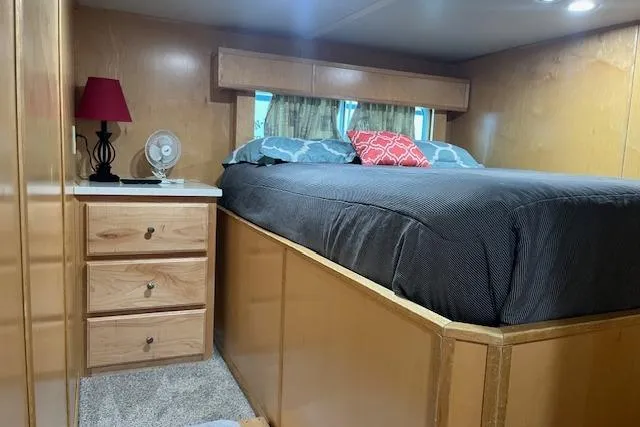 Slide: The Image of Cozy bedroom interior of 2003 Fantasy 18x80 Houseboat with wooden furnishings and modern decor. - 17