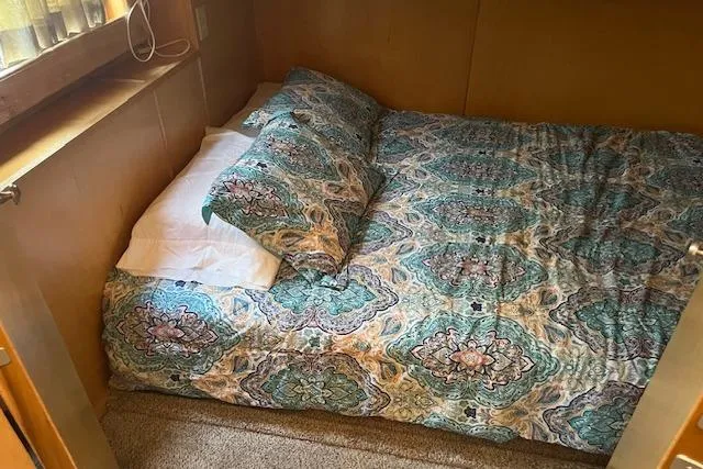 Slide: The Image of Cozy bedroom with patterned bedding in a 2003 Fantasy 18x80 houseboat. - 22